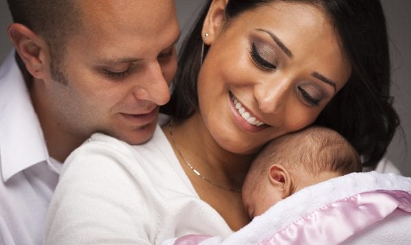 Happy Young Attractive Mixed Race Family With Newborn Baby.
