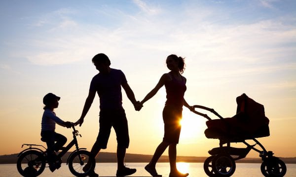 Happy Family Walking On Sunset