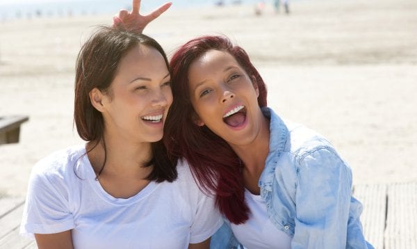 Cheerful Sisters Having Fun At The Beach